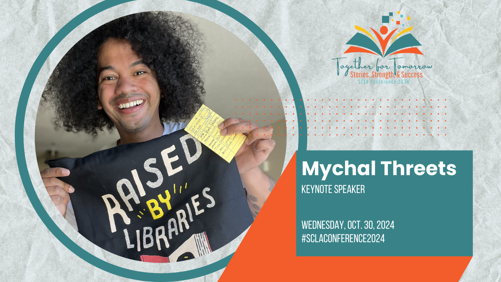A photo of Mychal Threets holding up a shirt that says Raised by Libraries. 